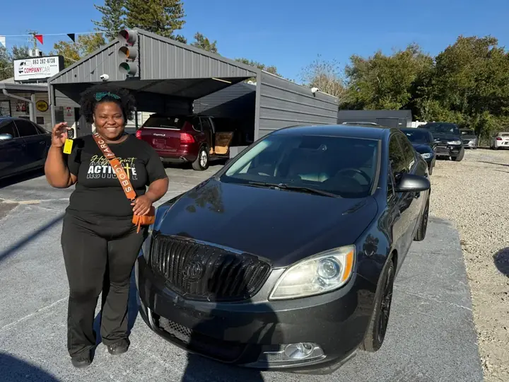 Customer holding the keys to their new Buick